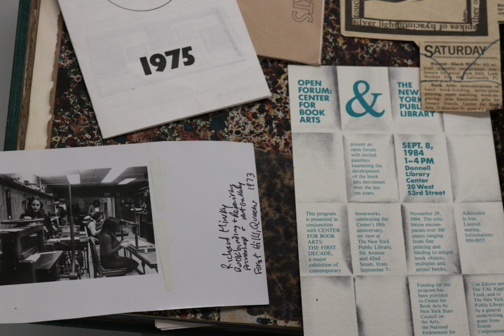 Various images laid out in a scrapbook mapping the Center's first ten years, including a black and white photograph of people working in our bindery, taken by Richard Minsky, and a poster for an open forum in 1984