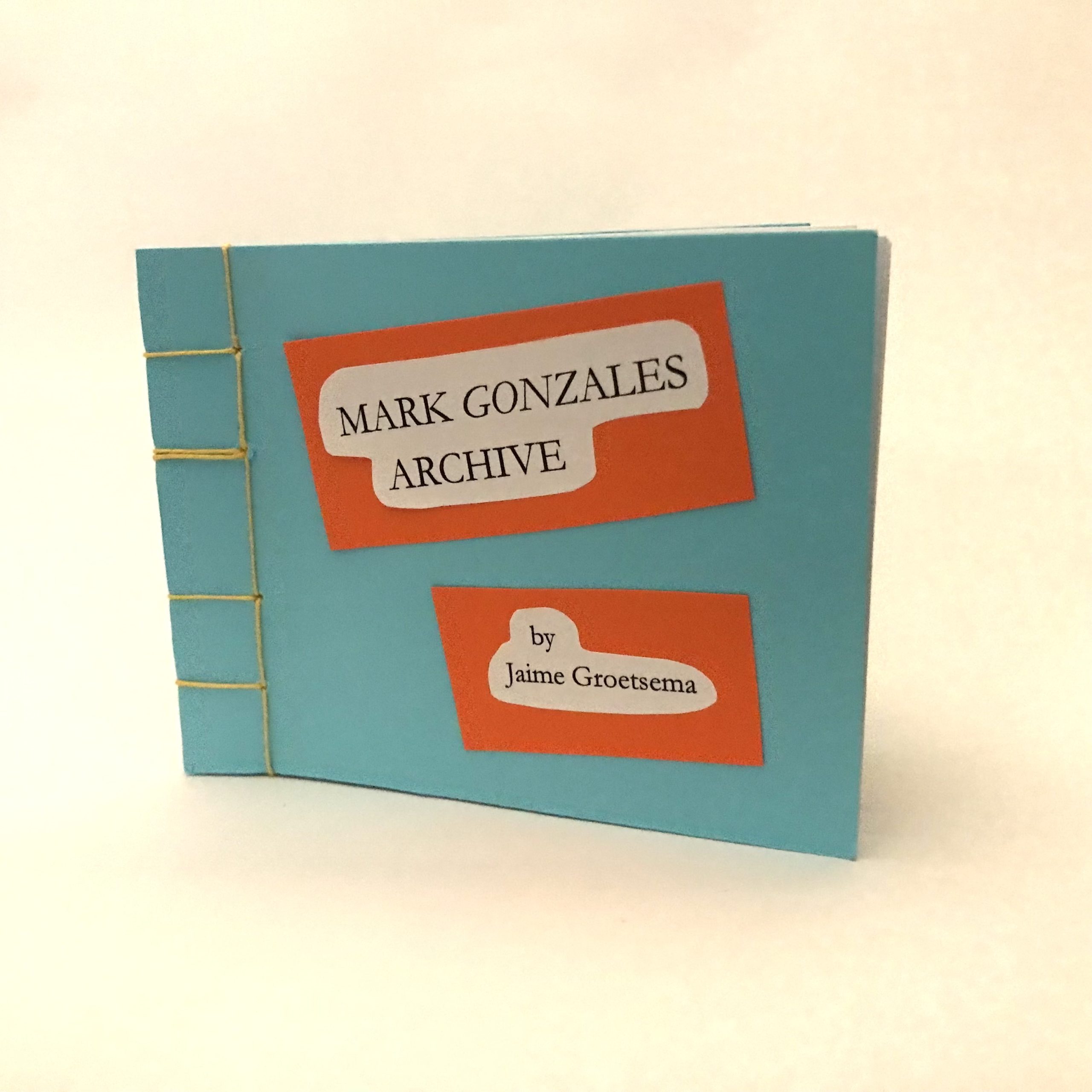 Artists' book standing upright on white background. Artists' book is rectangular with sky blue cover. Book is bound by yellow linen thread on one side in a stab-stitch style. Two rectangular labels are adhered to the cover. The labels are white, surrounded by an orange boarder. The label nearest the top of the cover reads: Mark Gonzales Archive; the label near the bottom of the cover reads: by: Jaime Groetsema. 